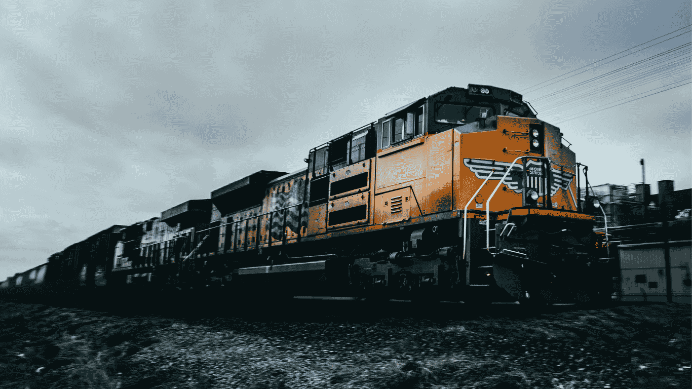 Road locomotive pulling a freight train under an overcast sky
